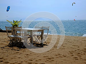 Dining table and chairs are located on Jomtien beach of Pattaya, Thailand.