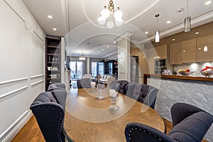 Dining table with chairs in luxury open plan apartment