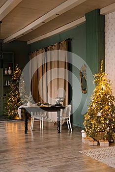 Dining table with chairs in a stylish Scandinavian living room with a Christmas tree