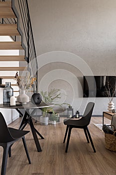 Dining table with decorations in room with tv