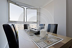 Dining table in a floor to ceiling window