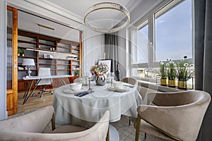 Dining table and office room in modern apartment