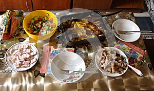 Dining table. Potatoes with fish, pieces of baked meat