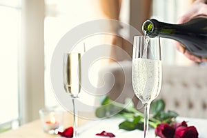 Dining table in restaurant close-up glasses of champagne pouring alcohol