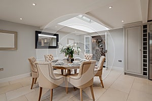 Dining table in room decorated in shades of white
