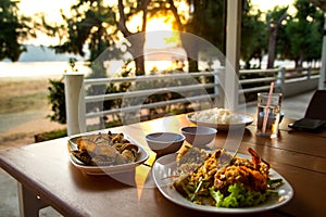 Dining table with seafoods with golden light on sunset