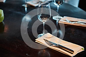 Dining table served with glasses, forks and knifes