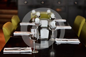 Dining table served with glasses, forks and knifes