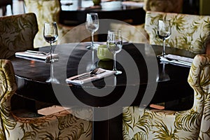 Dining table served with glasses, forks and knifes