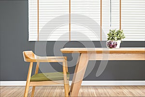 Dining table set with chair in the cozy dining room and dark grey wall