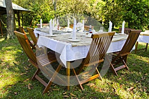 Dining table set in lush garden