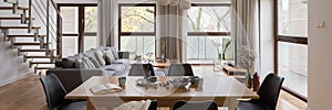 Dining table in spacious living room, panorama