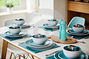 Dining Table with turquoise blue place settings