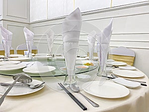 Dinner banquet table setting and elegant tableware in wedding hall