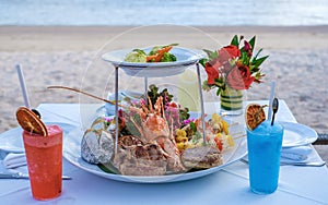 dinner on the beach with lobster and cocktails