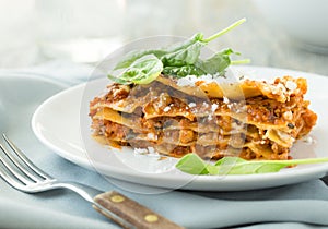 Dinner with classic lasagna bolognese with bÃÂ©chamel sauce parmesan cheese spinach