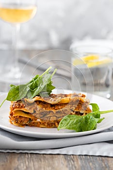 Dinner with classic lasagna bolognese with bÃ©chamel sauce parmesan cheese spinach