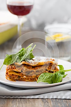 Dinner with classic lasagna bolognese with bÃ©chamel sauce parmesan cheese spinach