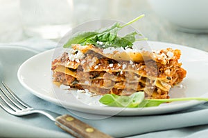 Dinner with classic lasagna bolognese with bÃ©chamel sauce parmesan cheese spinach