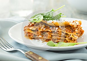 Dinner with classic lasagna bolognese with bÃ©chamel sauce parmesan cheese spinach