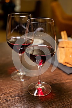 Dinner with glass of dry red wine in Italian osteria restaurant photo