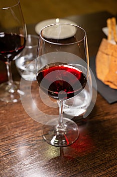 Dinner with glass of dry red wine in Italian osteria restaurant photo