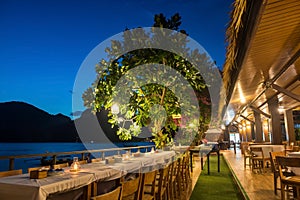 Dinner group table by Phi Phi Don sea at dusk