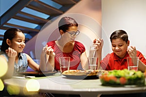 Dinner At Home With Happy Family Praying Before Eating