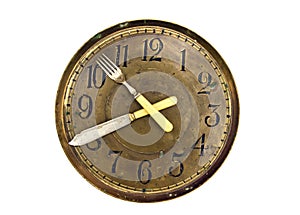 Dinner lunch time - old clock face dial with fork and knife arrows