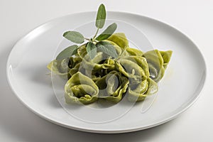 Dinner plate with green ravioli and sage