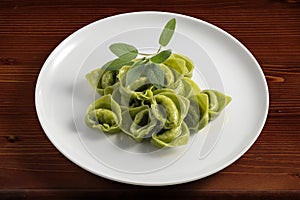 Dinner plate with green ravioli and sage