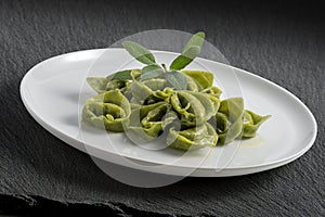 Dinner plate with green ravioli and sage