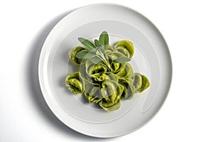 Dinner plate with green ravioli and sage