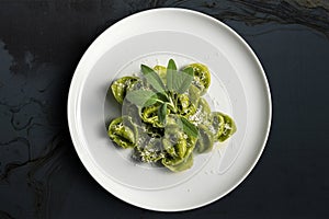 Dinner plate of green ravioli with sage and parmesan