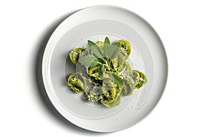 Dinner plate of green ravioli with sage and parmesan