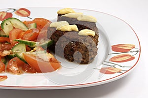 Dinner plate with kebab and vegetables