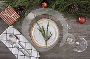 Dinner plate setting on wood table top view in christmas