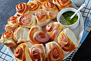 Dinner rolls with garlic sauce on a plate