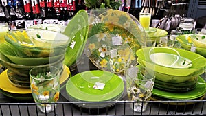 Dinner set, kitchen utensils displayed on supermarket shelves, including plates and cups