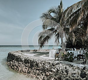 Summer vacation on a Maldives paradise tropical island. Dinner set-up on the oceanfront terrace.