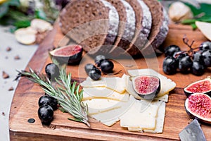 Dinner still life with rye bread, cheese and figs