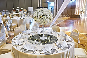 Dinner table arrangement with long vase of flower bouquet decoration