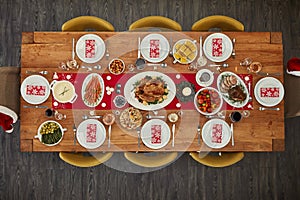 Dinner, table and Christmas lunch with food at an event from top view or above of a home dining room for celebration