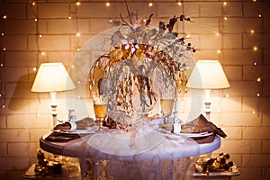 Dinner table sarved for two people decorated in winter style.