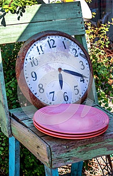 Dinner time concept, clock and plates