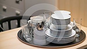 Dinnerware set close up on wooden table in elegant modern kitchen house interior
