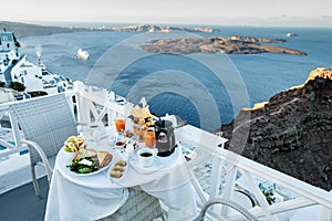 Dinning with cliff top views of the volcanic caldera in Santorini