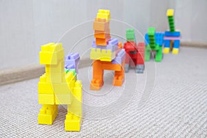 Dinosaur figurines made with plastic constructor block kit toys