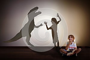 Dinosaur shadow in child dream. Kids read, imagine