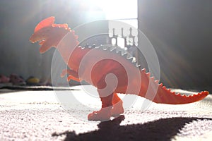 Dinosaur toy in the morning lights